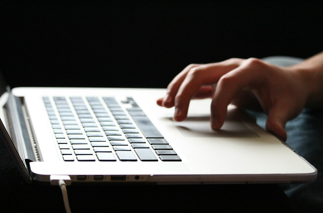 writer typing on laptop at night